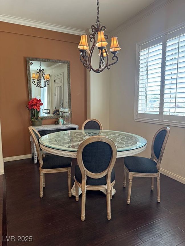 Dining area with a chandelier, crown molding, and dark wood-style floors | Image 7
