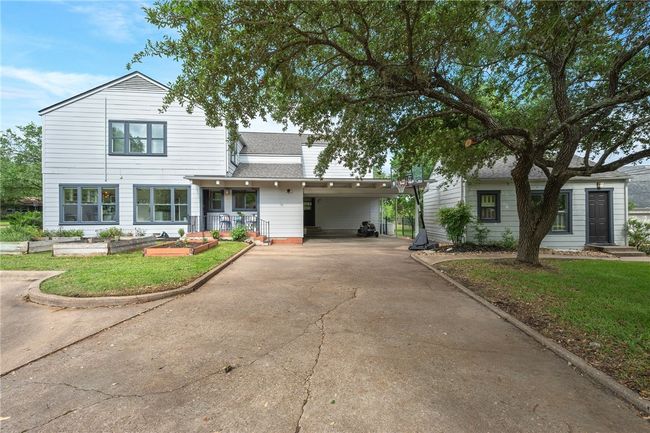 View of front facade with driveway, roof with shingles, a front lawn, and a carport | Image 41