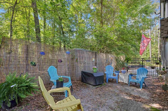 Fenced backyard with a grill | Image 34