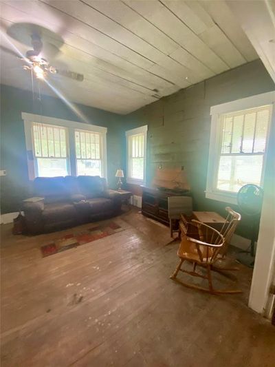 Living area featuring hardwood floors and ceiling fan | Image 3