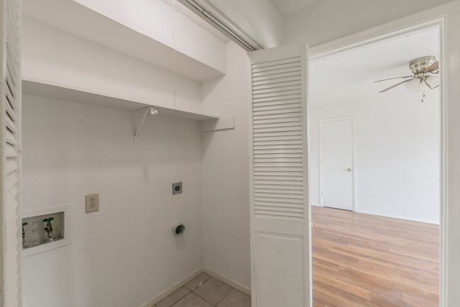 Laundry room with electric dryer hookup, washer hookup, a ceiling fan, and baseboards | Image 23