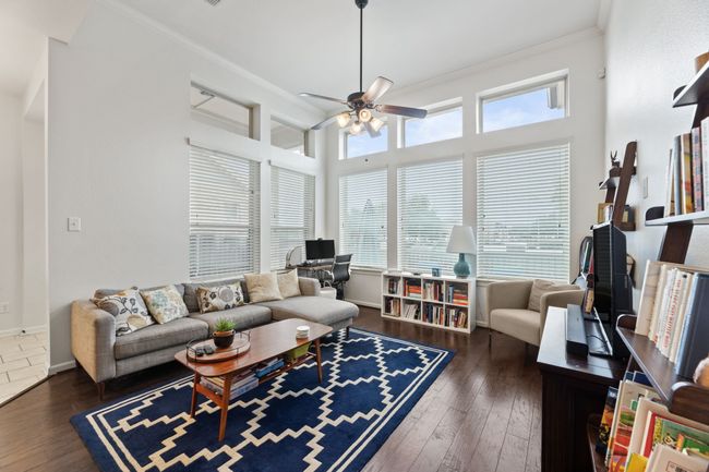 Living room with crown molding, ceiling fan, hardwood / wood-style flooring, and baseboards | Image 14