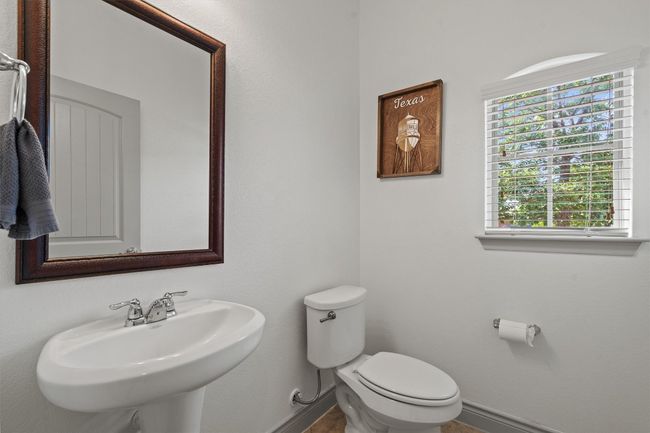 Bathroom featuring baseboards, toilet, and a sink | Image 17