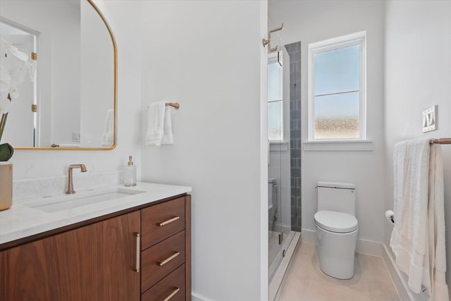 Bathroom with tile patterned floors, toilet, a shower, vanity, and baseboards | Image 14