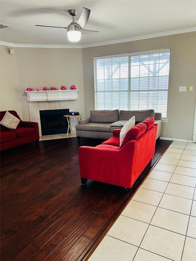 Living room featuring a healthy amount of sunlight, ornamental molding, and hardwood / wood-style floors | Image 7