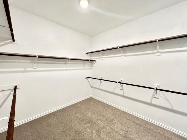 Spacious closet with carpet flooring | Image 17
