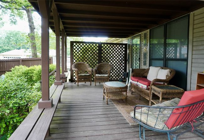 Wooden terrace with an outdoor living space and fence | Image 20