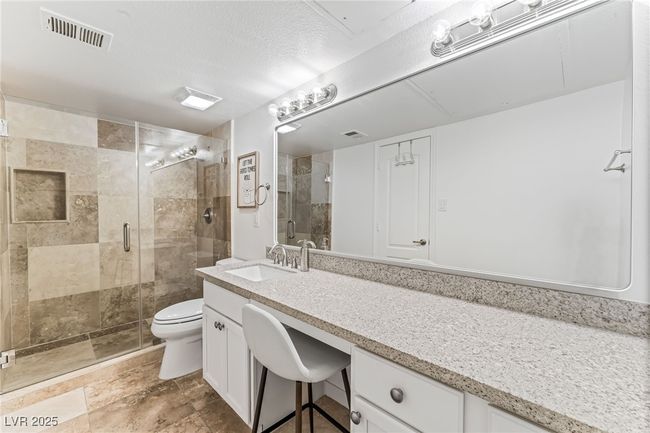 Bathroom with a shower stall, vanity, and toilet | Image 20