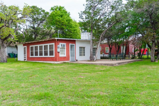 Back of property featuring a patio area, a chimney, and a lawn | Image 5