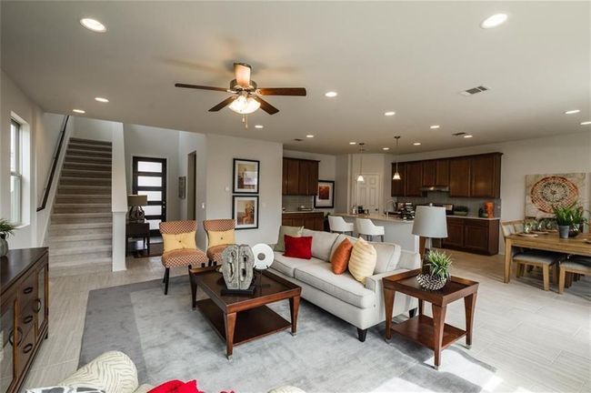 Living room featuring recessed lighting, a ceiling fan, healthy amount of natural light, and stairway | Image 17