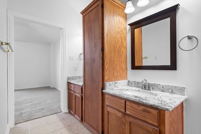 The updated primary bath has tons of storage and two vanities. | Image 29