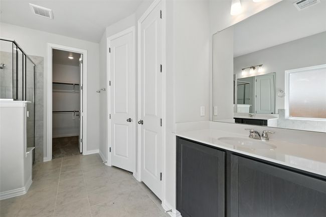 Bathroom with a shower stall, vanity, and a walk in closet | Image 18