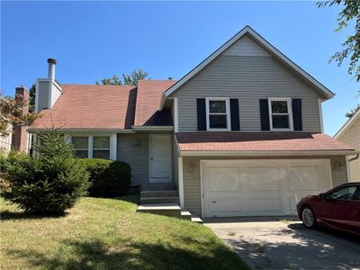 View of front of property featuring a garage and a front yard | Image 1