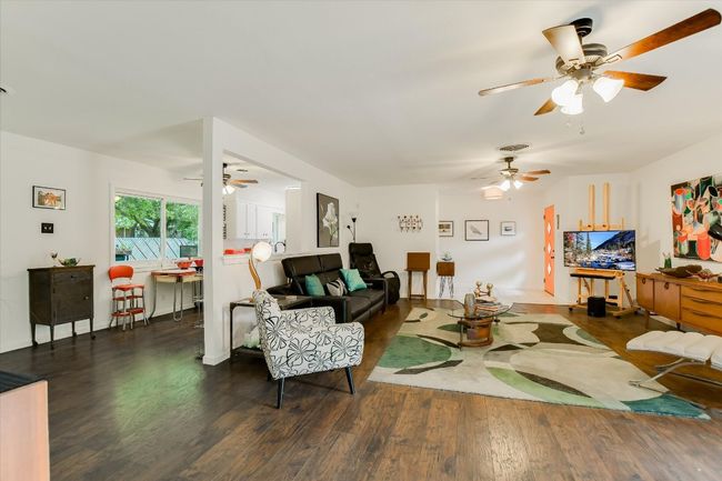 Living room featuring a ceiling fan and wood finished floors | Image 6