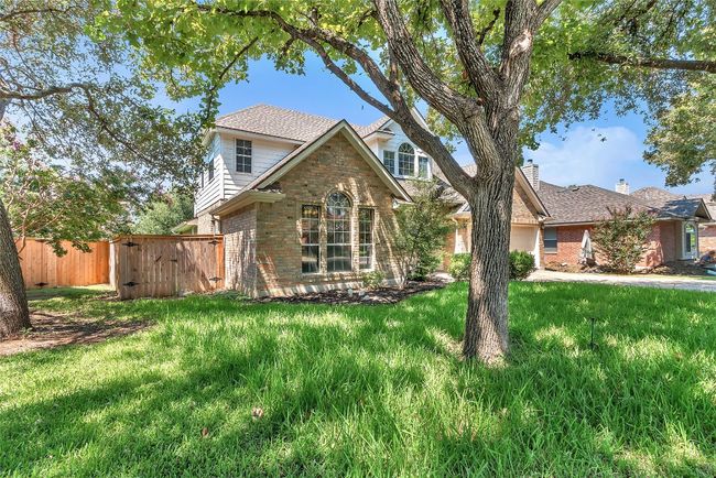Traditional home featuring brick siding and a gate | Image 27