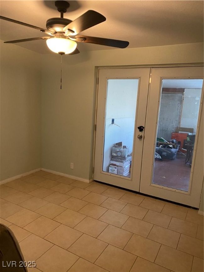 Unfurnished room with baseboards, a ceiling fan, and french doors | Image 32