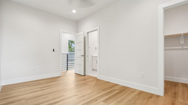 Unfurnished bedroom with a spacious closet, light wood finished floors, recessed lighting, and a ceiling fan | Image 20