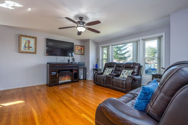 Living room with hardwood floors, baseboards and ceiling fan | Image 11