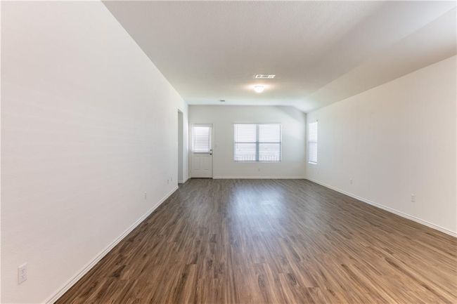 Empty room featuring baseboards and dark wood finished floors | Image 18