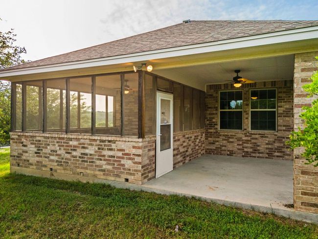 View of exterior entry with a patio area, brick siding, and a ceiling fan | Image 36
