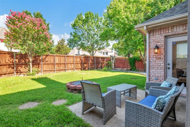 backyard has a custom built fire pit in the sitting area | Image 31