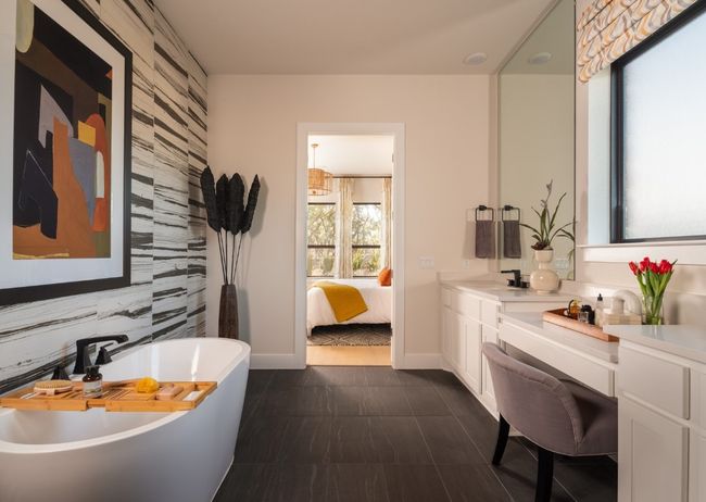 Bathroom with a freestanding tub, vanity, and an accent wall | Image 8