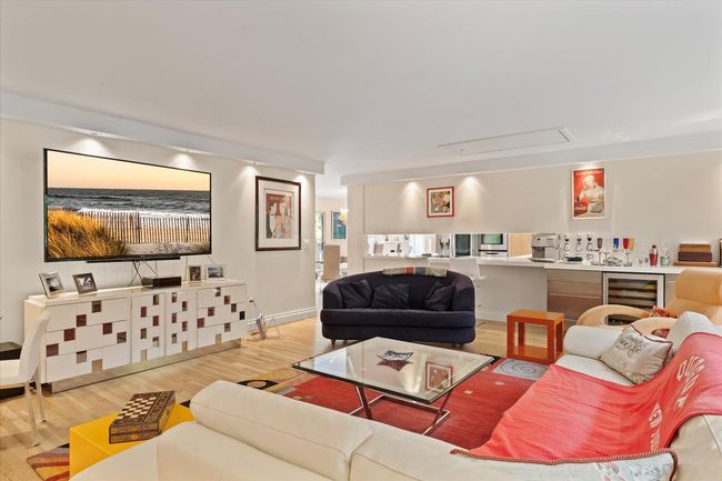 Living room featuring beverage cooler, attic access, and wood finished floors | Image 8