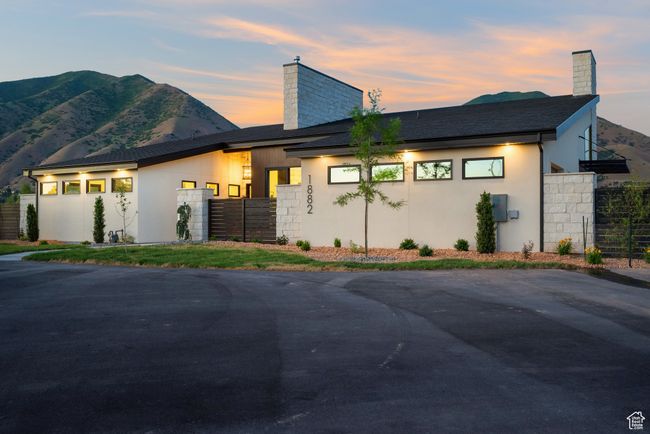 Modern home featuring a chimney, stucco siding, and a mountain view | Image 5