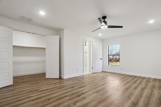 Unfurnished bedroom featuring recessed lighting, wood finished floors, visible vents, and baseboards | Image 16
