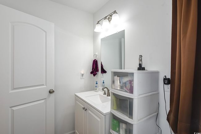 Bathroom featuring vanity and washer / dryer | Image 20