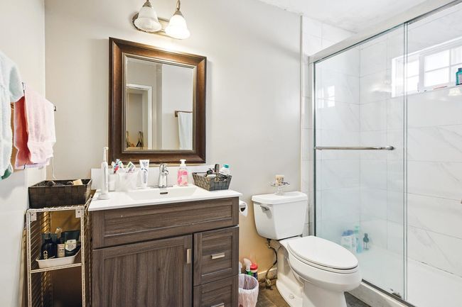 Bathroom with vanity, toilet, and a shower stall | Image 20