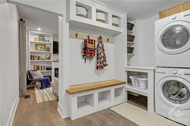 New Mud Room/ Laundry Room with convienent bench, and storage and stackable LG washer/dryer | Image 15