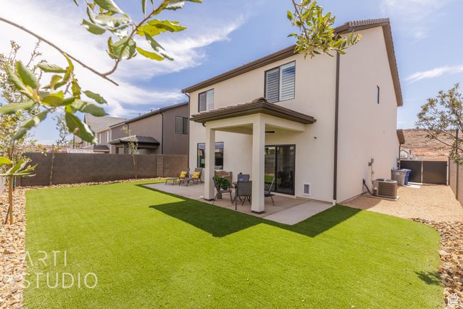 Back of property with stucco siding, a patio area, a yard, and a fenced backyard | Image 37