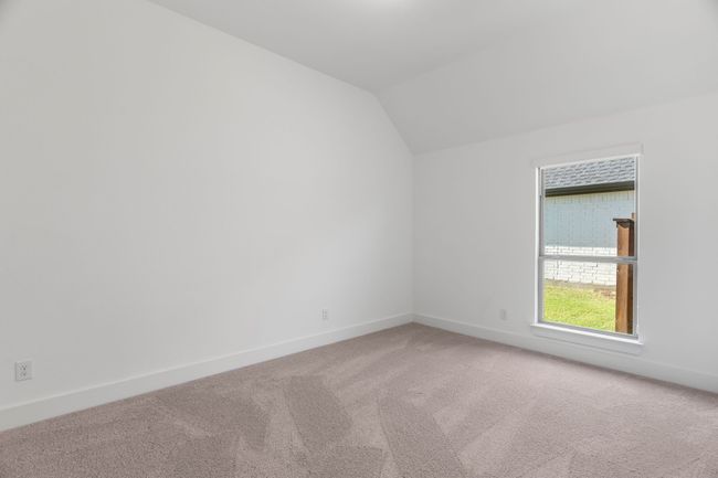 Carpeted spare room with lofted ceiling and baseboards | Image 13