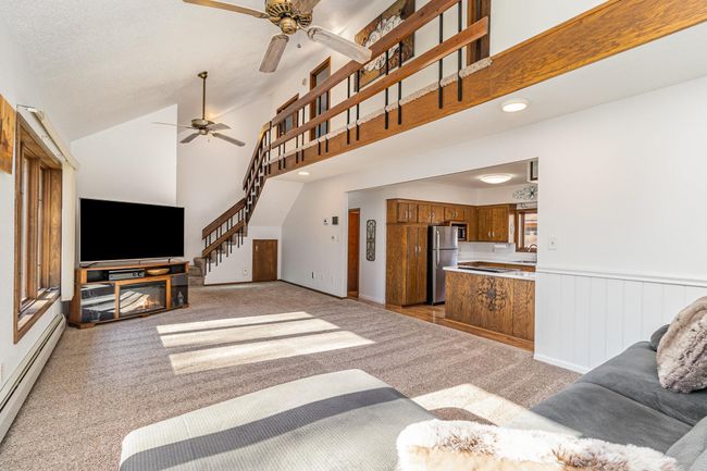 The upper-level hallway is open to the great room, making the space feel bright, open & airy. The great room is also open to the kitchen. | Image 14