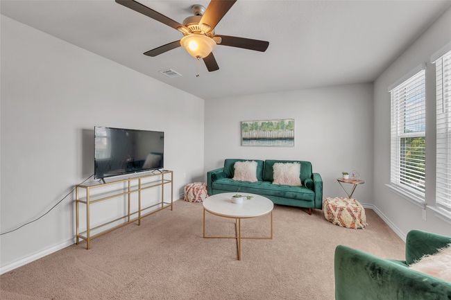Living area featuring carpet floors, baseboards, and ceiling fan | Image 15