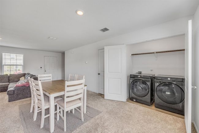 Dining area featuring washer and clothes dryer, recessed lighting, and light carpet | Image 15