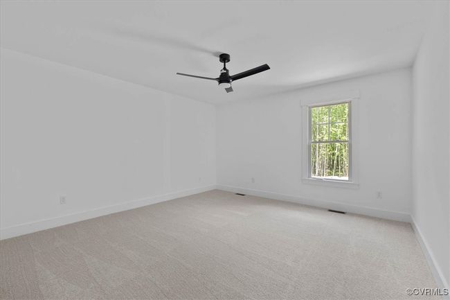Spare room featuring baseboards, ceiling fan, visible vents, and carpet | Image 22