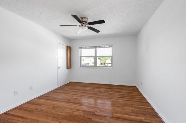 Room featuring ceiling fan, baseboards, wood finished floors, and a textured ceiling | Image 17