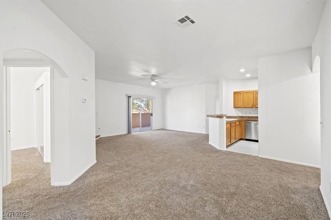 Unfurnished living room with visible vents, recessed lighting, arched walkways, ceiling fan, and light carpet | Image 4