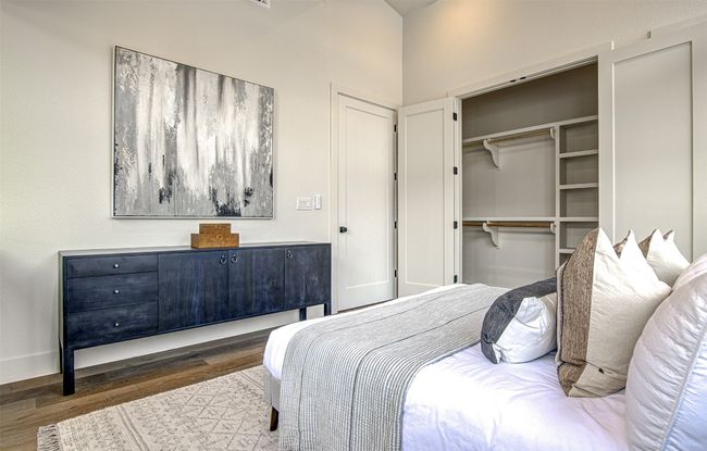 Bedroom with wood finished floors and a closet | Image 14