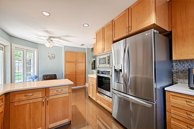 Peninsula adjacent to the stainless refrigerator. | Image 26