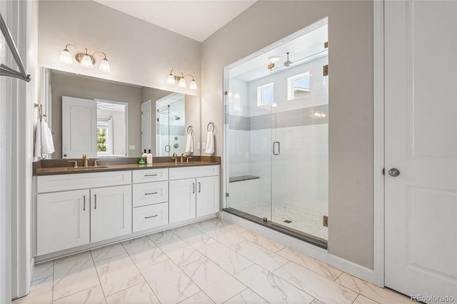 Primary spa-like ensuite with oversized shower (complete with rain shower head), linen closet and beautiful tile work. | Image 23
