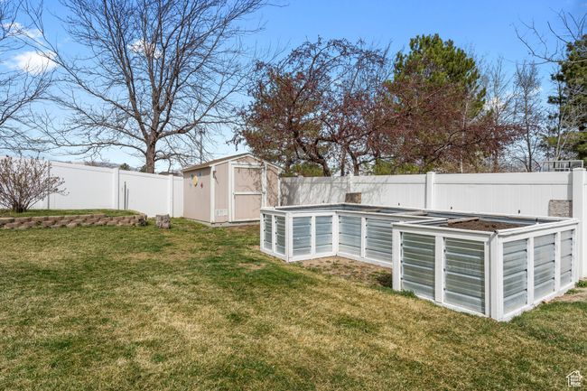 View of yard and raised garden or flower beds | Image 33