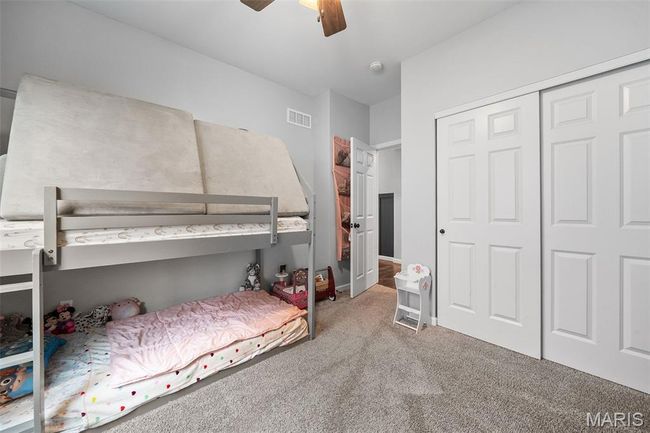 Carpeted bedroom with a closet and ceiling fan | Image 24