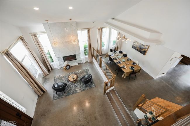 Living room featuring recessed lighting, a fireplace, baseboards, and an inviting chandelier | Image 9
