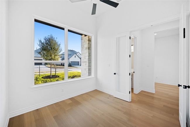 Unfurnished bedroom with light wood-type flooring and ceiling fan | Image 22