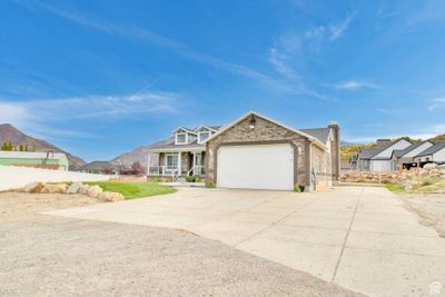 View of front of home featuring a front yard, a garage, and a mountain view | Image 3