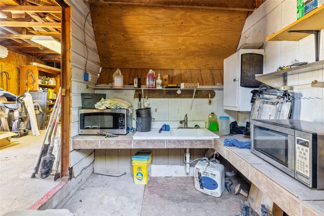 Misc room with a sink and unfinished concrete floors | Image 25