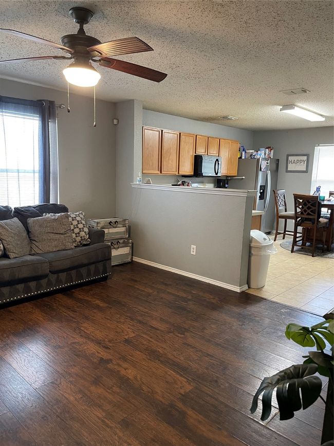 Living area with wood-style flooring and ceiling fan | Image 4
